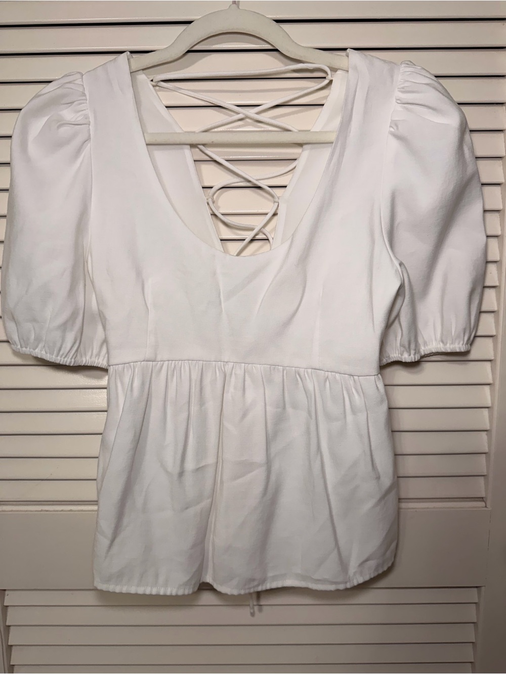 White Puff-Sleeve Peplum Tunic with Lace-Up Back